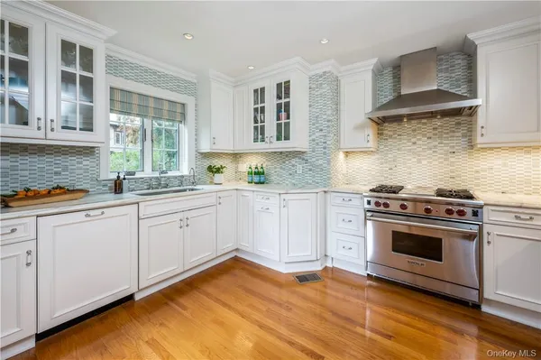 a kitchen with stainless steel appliances granite countertop a stove and a sink