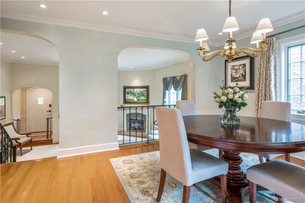 a view of a dining room with furniture and a chandelier