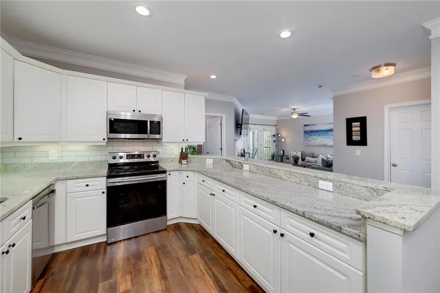 a view of a kitchen counter space and dining room