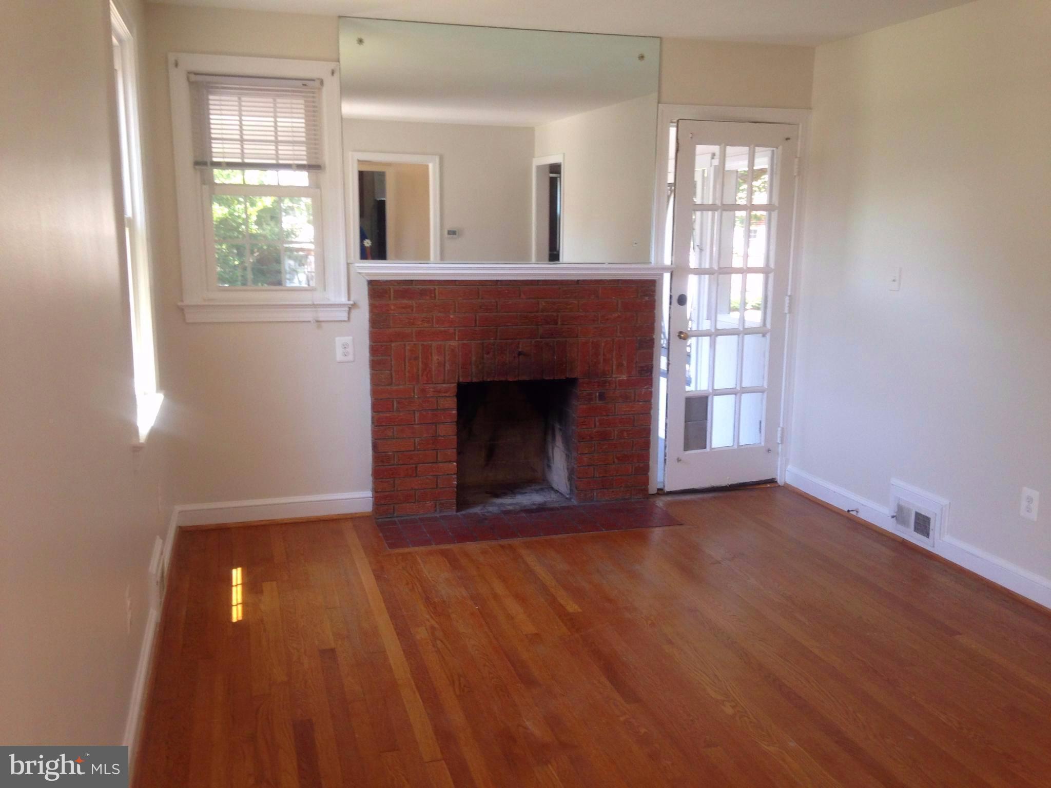 505 Stirling Road Silver Spring, MD 20901 - Photo 2 of 26 Hardwood floor and fireplace/door to screened porc