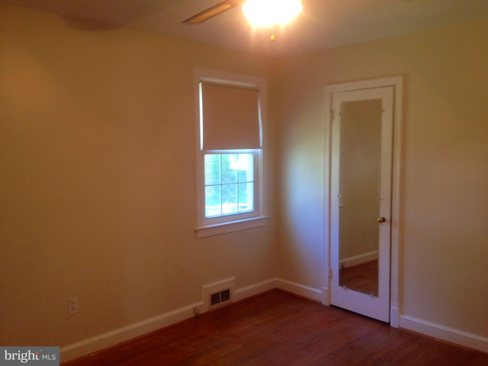 505 Stirling Road Silver Spring, MD 20901 - Photo 6 of 26 Hardwood floors and ceiling fan in bedroom 1