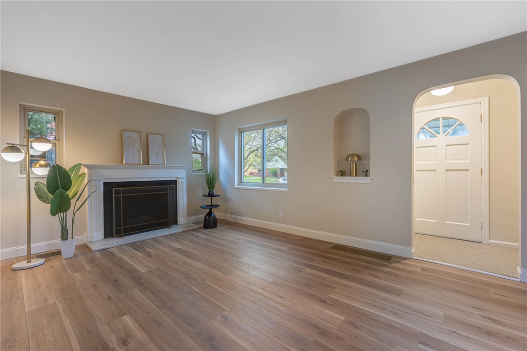1012 Hampshire Road Dayton, OH 45419 - Photo 6 of 39 This living room features a classic fireplace and gleaming hardwood floors, creating an inviting atmosphere.