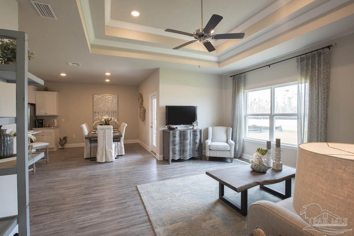 6007 Rutherford Loop Pensacola, FL 32526 - Photo 16 of 19 a living room with furniture a flat screen tv and a large window