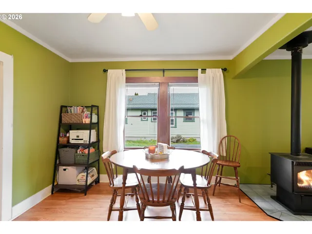 a dining room with furniture and wooden floor