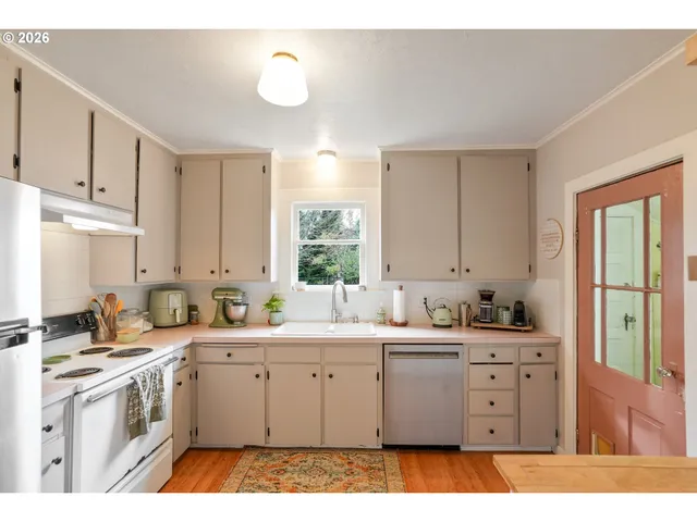 a kitchen with a sink stove and cabinets