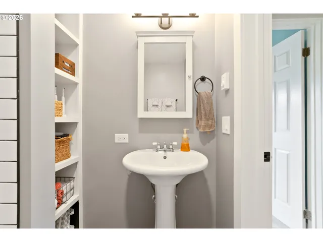 a bedroom with a bed mirror and window