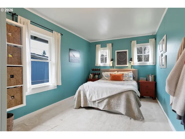 a bedroom with a large bed and a window