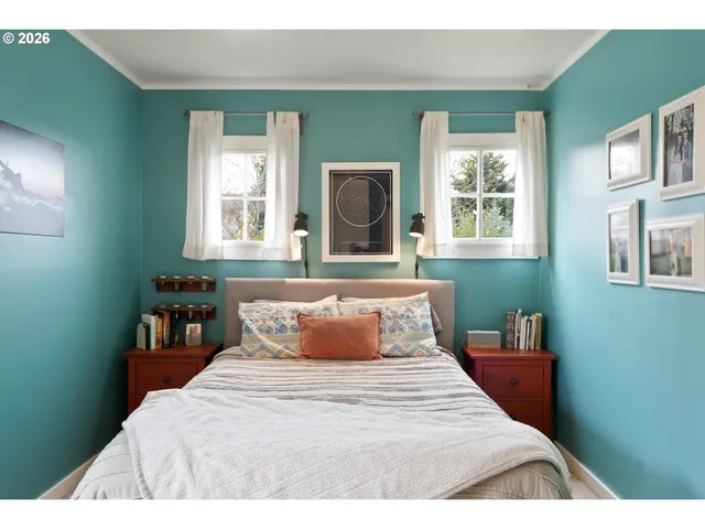 a view of a bedroom with window and cabinet