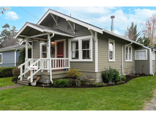 a front view of a house with a garden