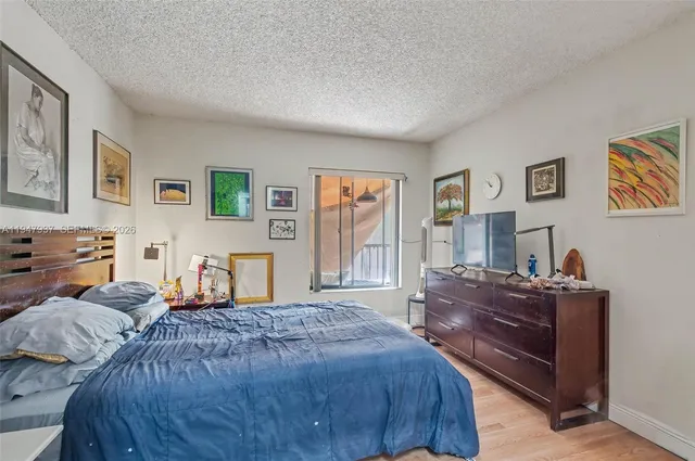 a bed room with two bed and paintings on the wall