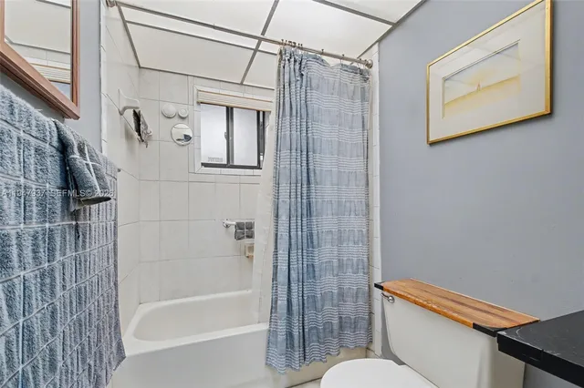 a bathroom with a shower a toilet and a shower