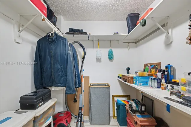 a view of storage and utility room with fridge and rack