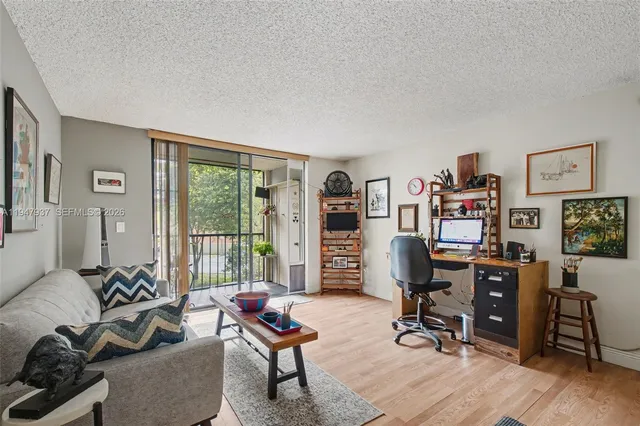 a view of a livingroom with workspace and a couch