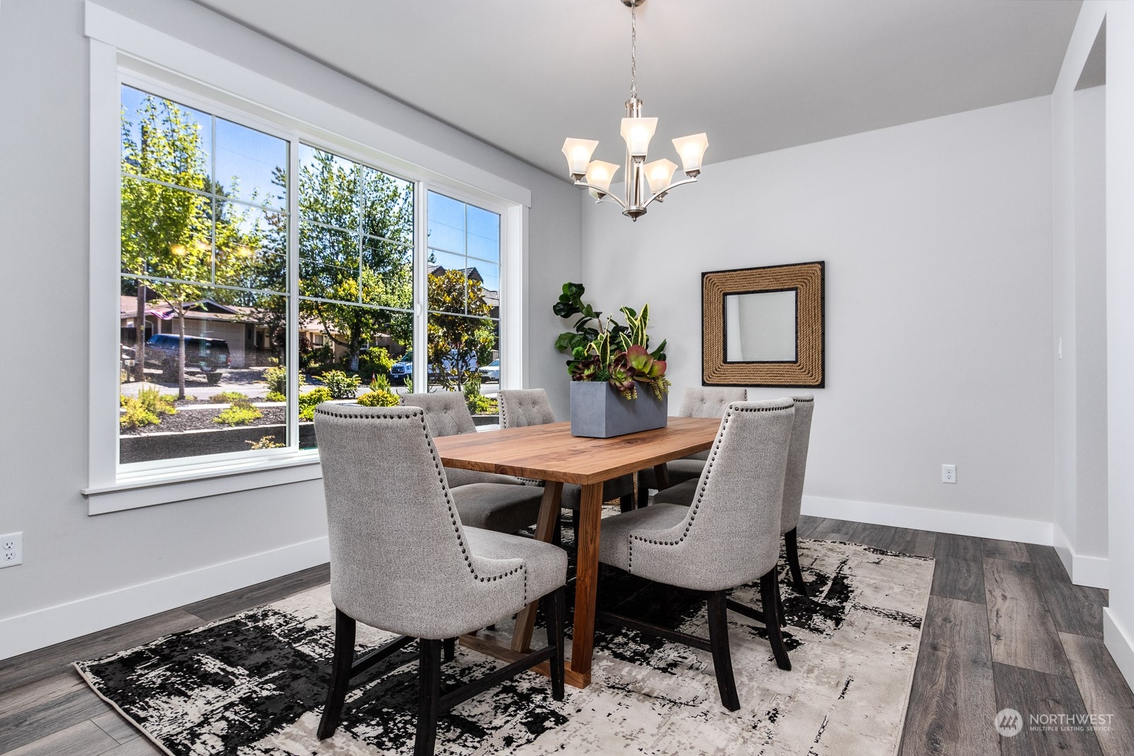 859 Field Avenue Northeast Renton, WA 98059 - Photo 13 of 27 a dining room with furniture a rug and a chandelier
