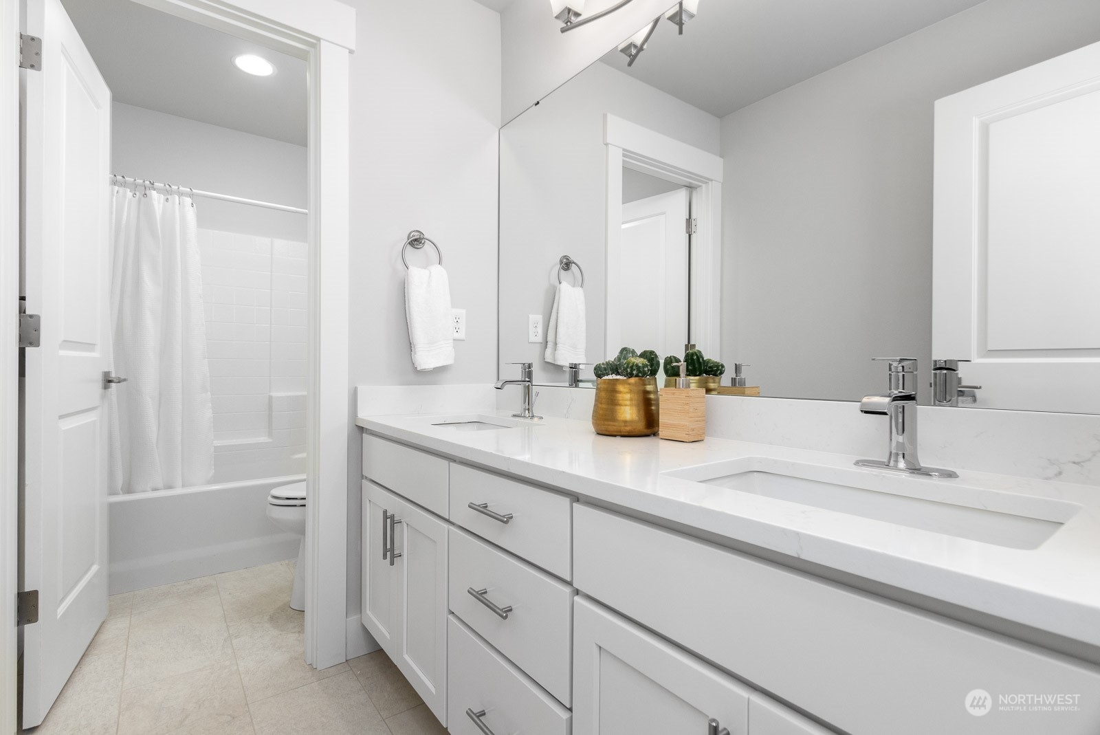 859 Field Avenue Northeast Renton, WA 98059 - Photo 16 of 27 a bathroom with a double vanity sink and a mirror