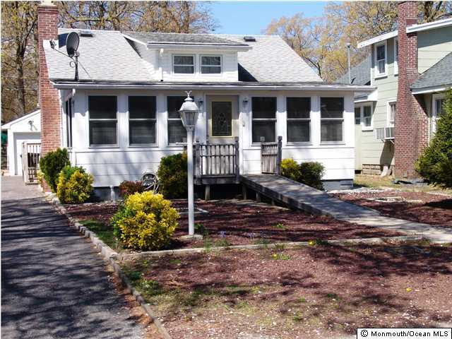 212 Bash Road Toms River, NJ 08753 - Photo 1 of 3 a front view of a house with a yard and outdoor seating