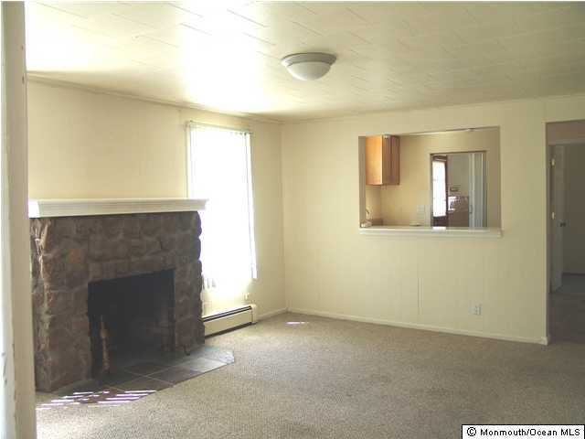 212 Bash Road Toms River, NJ 08753 - Photo 3 of 3 a view of a livingroom with wooden floor and a fireplace