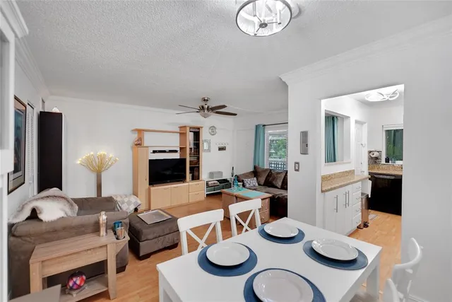 a living room with furniture and a dining table