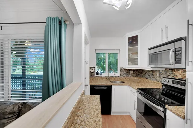 a kitchen with a stove a sink and a microwave