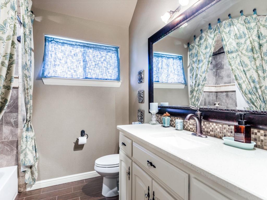 259 Hidden Creek Road Cresson, TX 76035 - Photo 15 of 28 Bathroom with vanity, wood finish floors, shower / tub combo, and tasteful backsplash