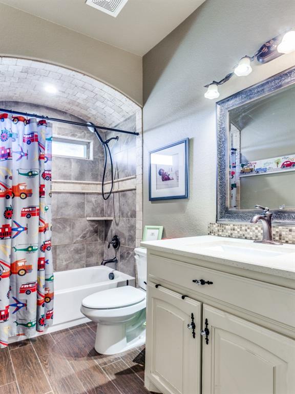 259 Hidden Creek Road Cresson, TX 76035 - Photo 17 of 28 Full bath featuring vanity, shower / bathtub combination with curtain, and wood tiled floors