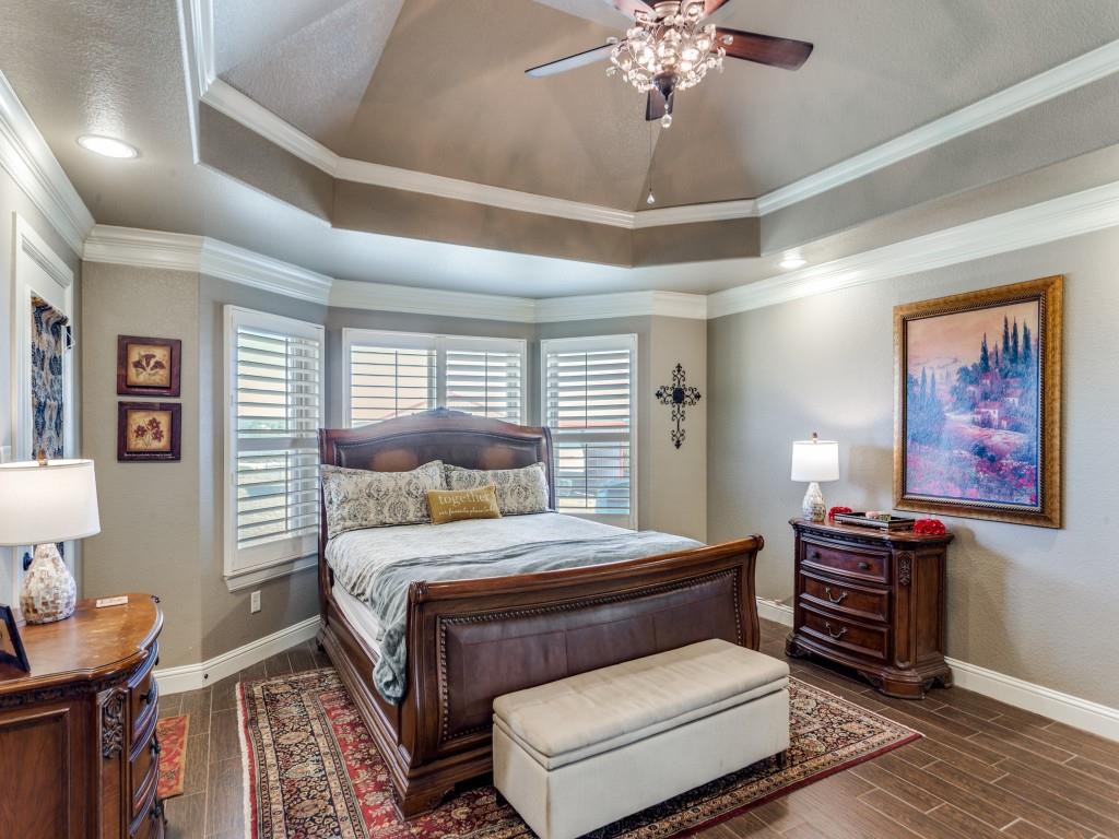 259 Hidden Creek Road Cresson, TX 76035 - Photo 18 of 28 Bedroom featuring wood finish floors, ornamental molding, ceiling fan, a tray ceiling, and recessed lighting