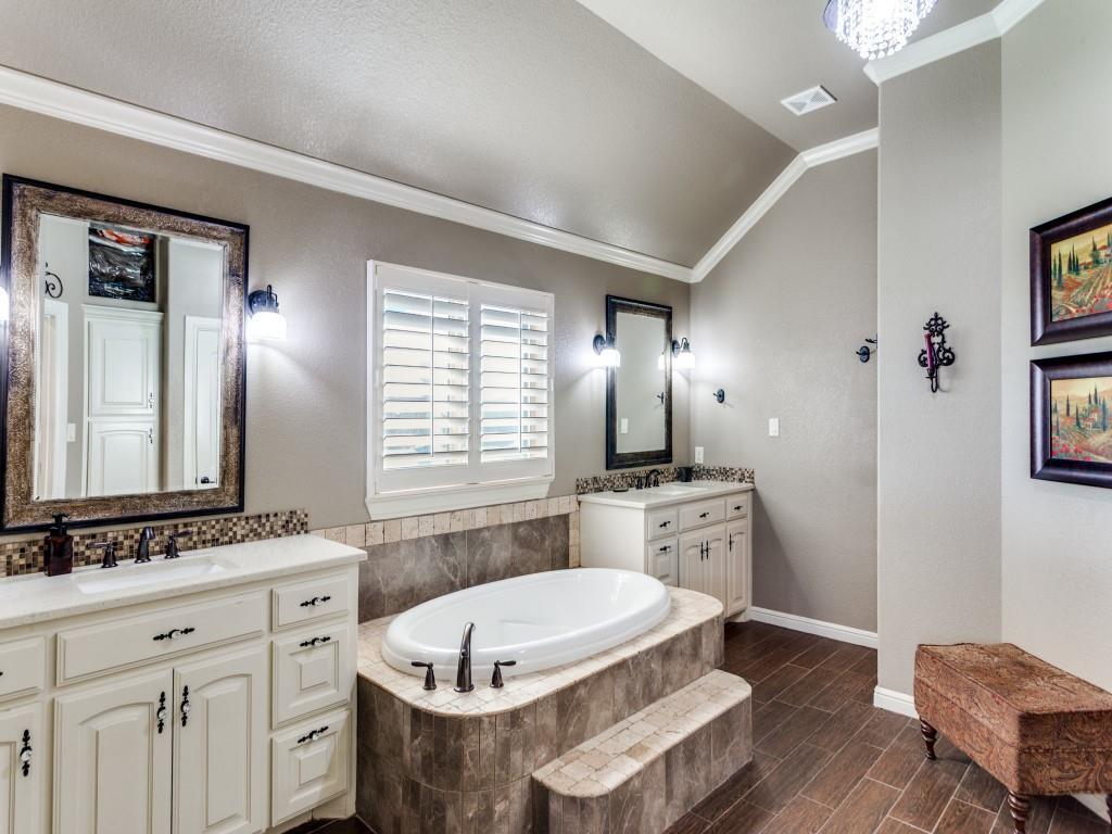 259 Hidden Creek Road Cresson, TX 76035 - Photo 20 of 28 Full bath with ornamental molding, lofted ceiling, two vanities, a garden tub, and wood tiled floors