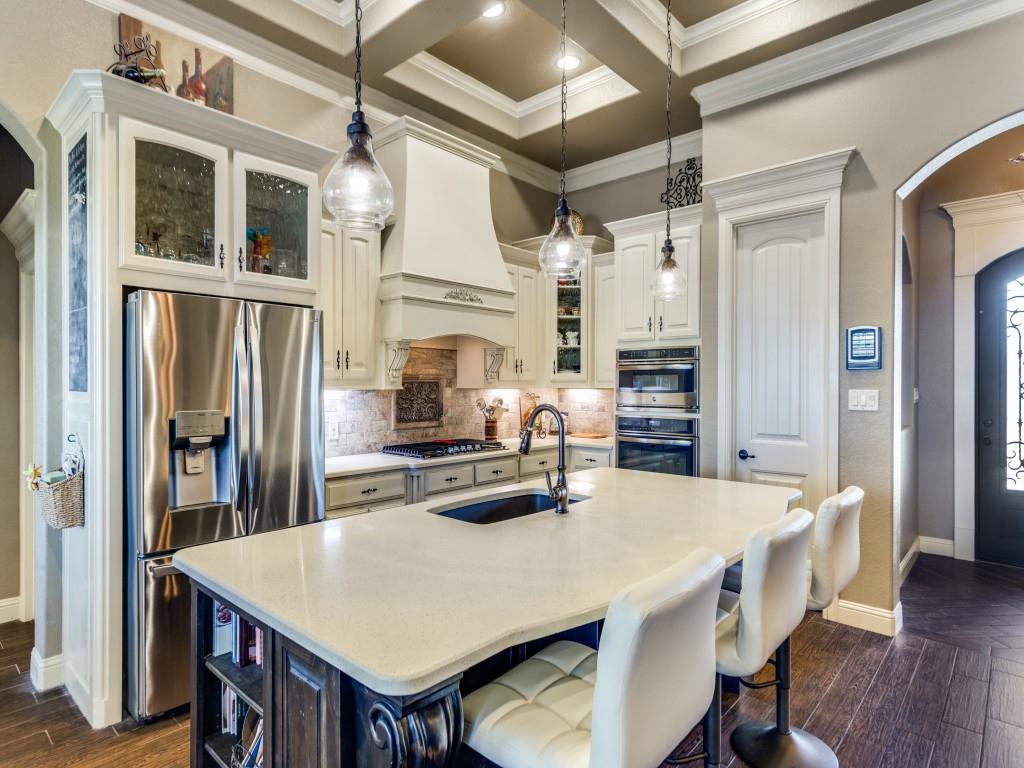 259 Hidden Creek Road Cresson, TX 76035 - Photo 8 of 28 Dual tone kitchen featuring arched walkways, glass insert cabinets, dark wood-style flooring, coffered ceiling, and dual tone cabinets