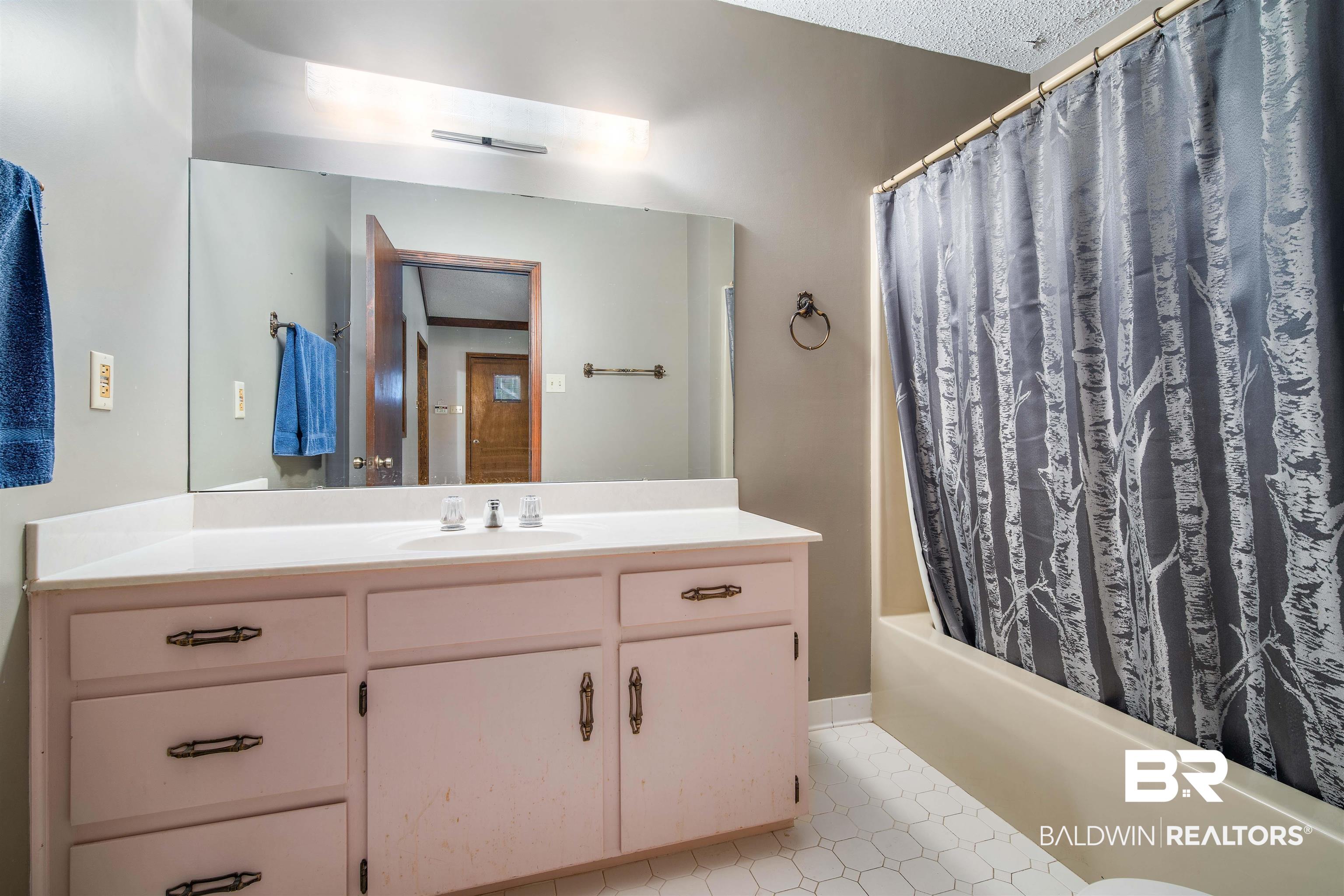 2300 Ellen Drive Mobile, AL 36605 - Photo 7 of 25 Bathroom with vanity, a textured ceiling, and shower / tub combo