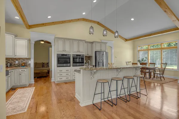 a large kitchen with stainless steel appliances kitchen island granite countertop a large counter top and stainless steel appliances