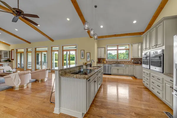 a living room with furniture a flat screen tv and a large window