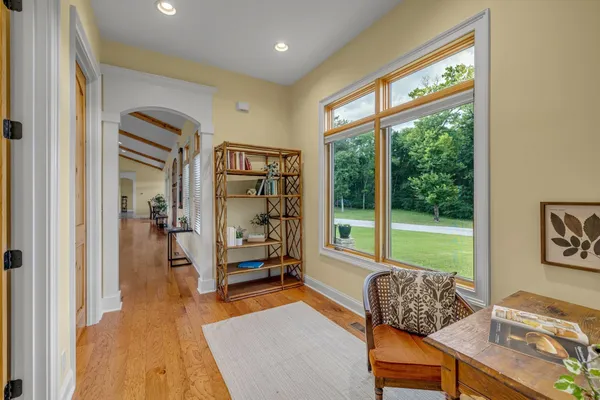a bedroom with a bed and a large window with outer view