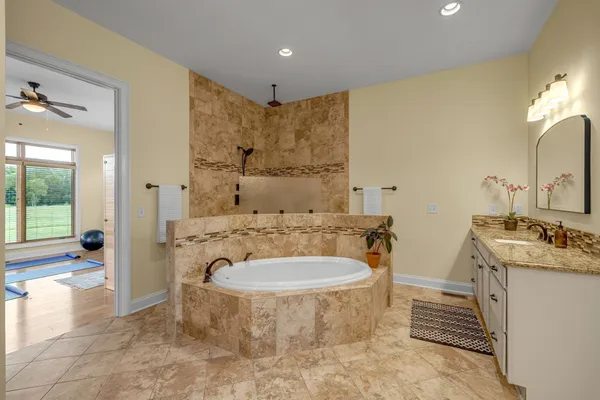 a view of a workspace with wooden floor and a large window
