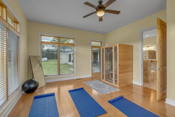 a view of room with window ceiling fan and hardwood floor