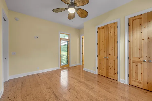 a bathroom with a granite countertop sink a toilet a mirror a bathtub and shower