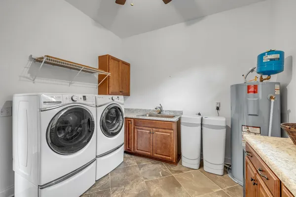 a view of a house with a big yard and potted plants