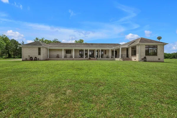 a view of a house with backyard and porch