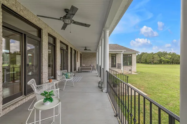 a view of a porch with a table and chairs