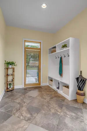a living room with furniture and large windows