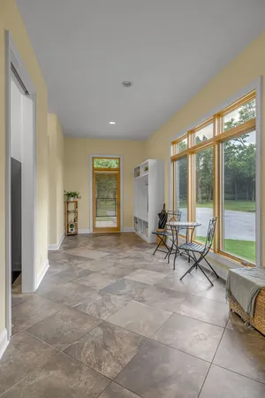 a living room with furniture and large windows