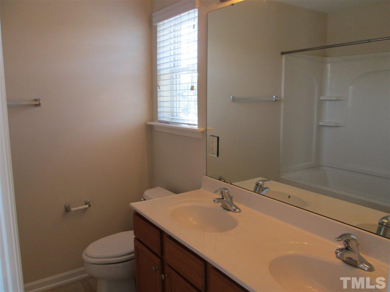 7706 River Field Drive Raleigh, NC 27616 - Photo 13 of 20 a bathroom with a sink toilet and vanity
