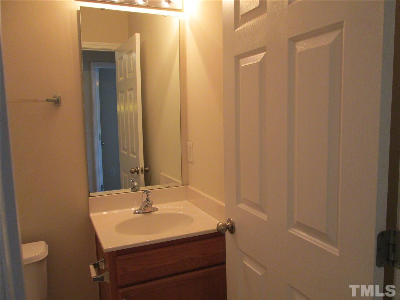7706 River Field Drive Raleigh, NC 27616 - Photo 17 of 20 a bathroom with a sink and a mirror