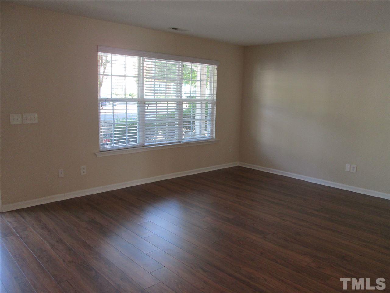 7706 River Field Drive Raleigh, NC 27616 - Photo 3 of 20 a view of an empty room with wooden floor and a window