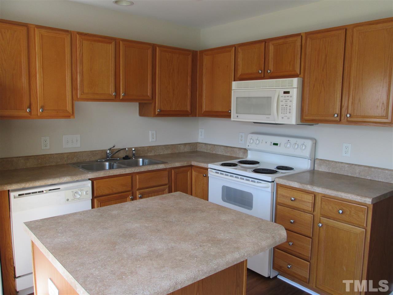 7706 River Field Drive Raleigh, NC 27616 - Photo 5 of 20 a kitchen with a stove a sink and a refrigerator
