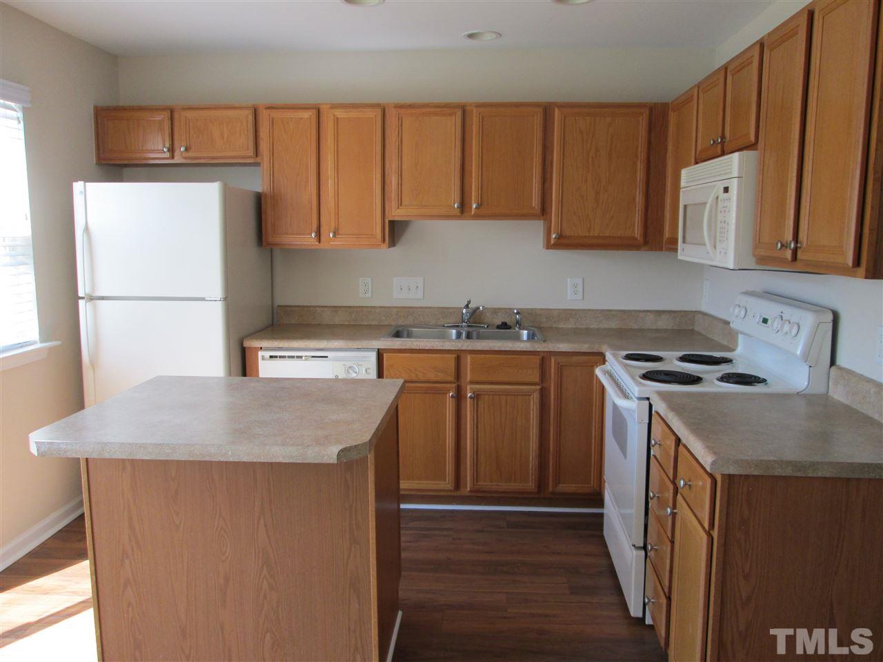 7706 River Field Drive Raleigh, NC 27616 - Photo 6 of 20 a kitchen with a sink stove and cabinets
