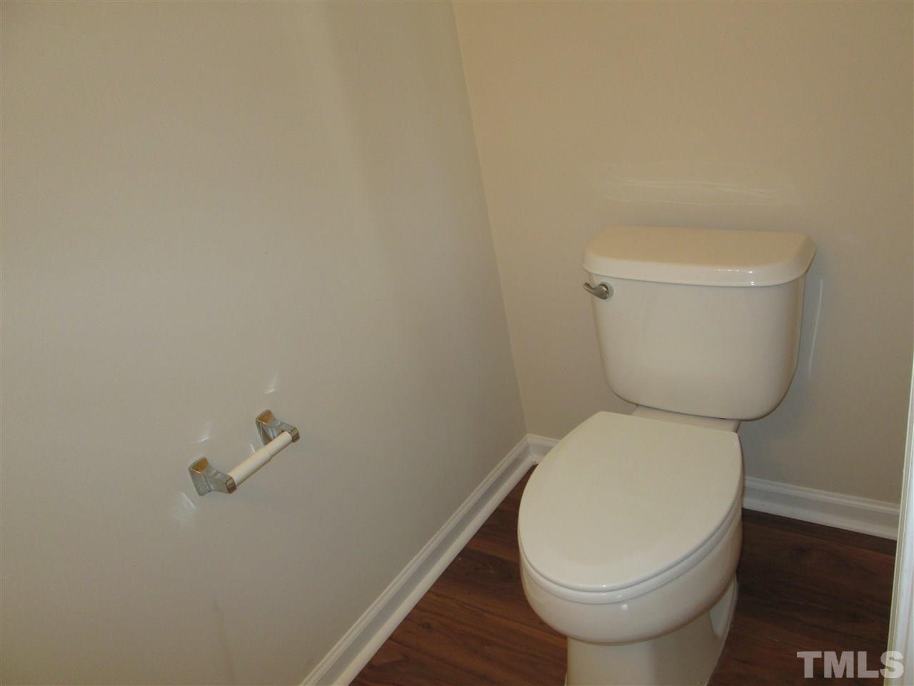 7706 River Field Drive Raleigh, NC 27616 - Photo 9 of 20 a white toilet sitting next to a white wall