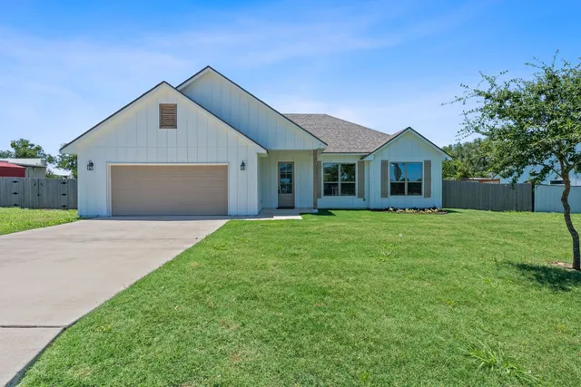 a front view of house with yard and green space