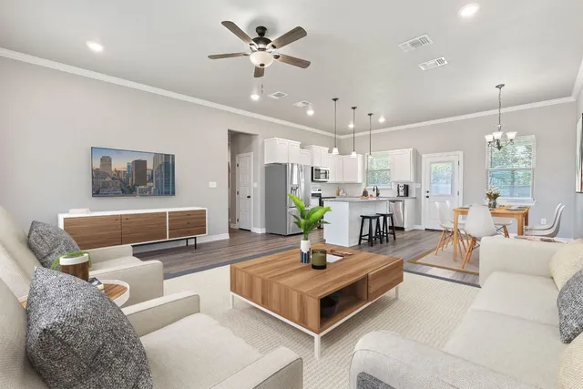 a living room with furniture and a chandelier