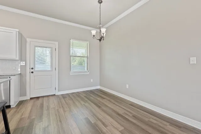 a view of a room with wooden floor and windows
