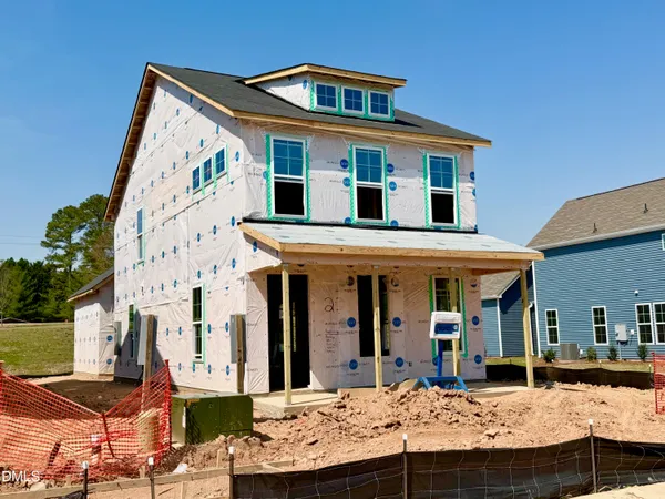 a view of a white house with large windows